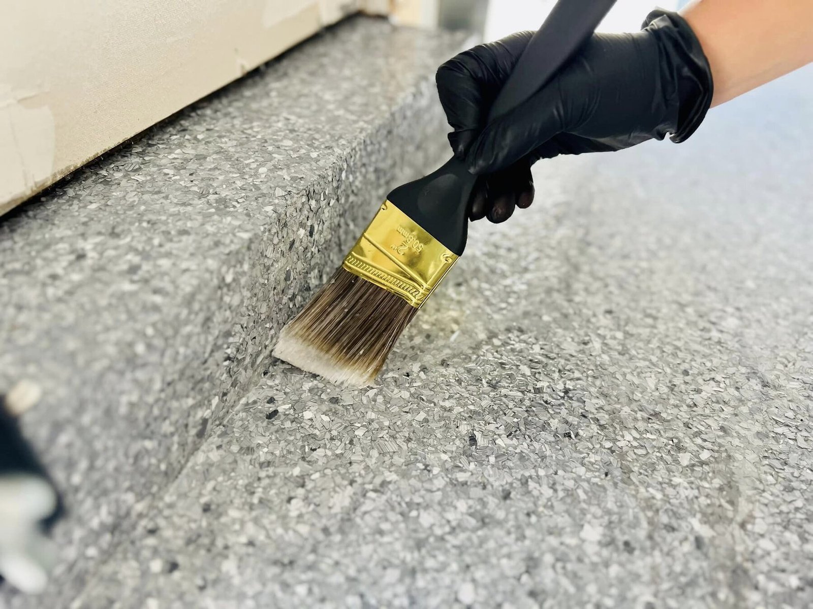 Technician applying a coating to a prepared floor