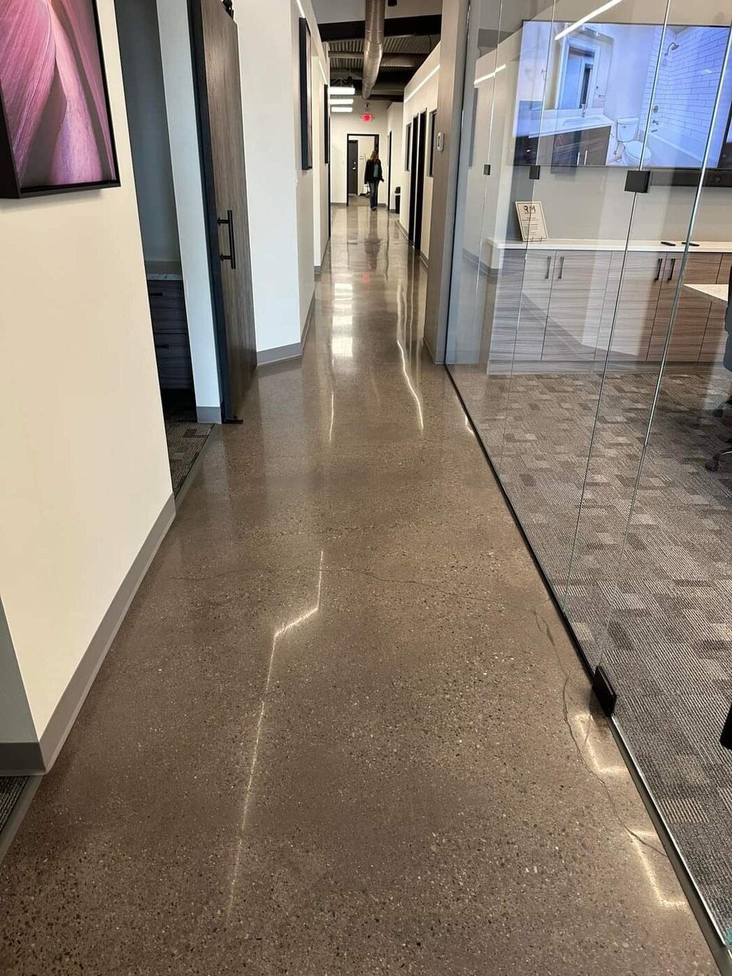 Glossy commercial resinous floor in a modern hallway