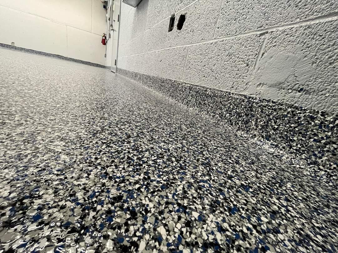 Close view of a flake epoxy floor and cove base