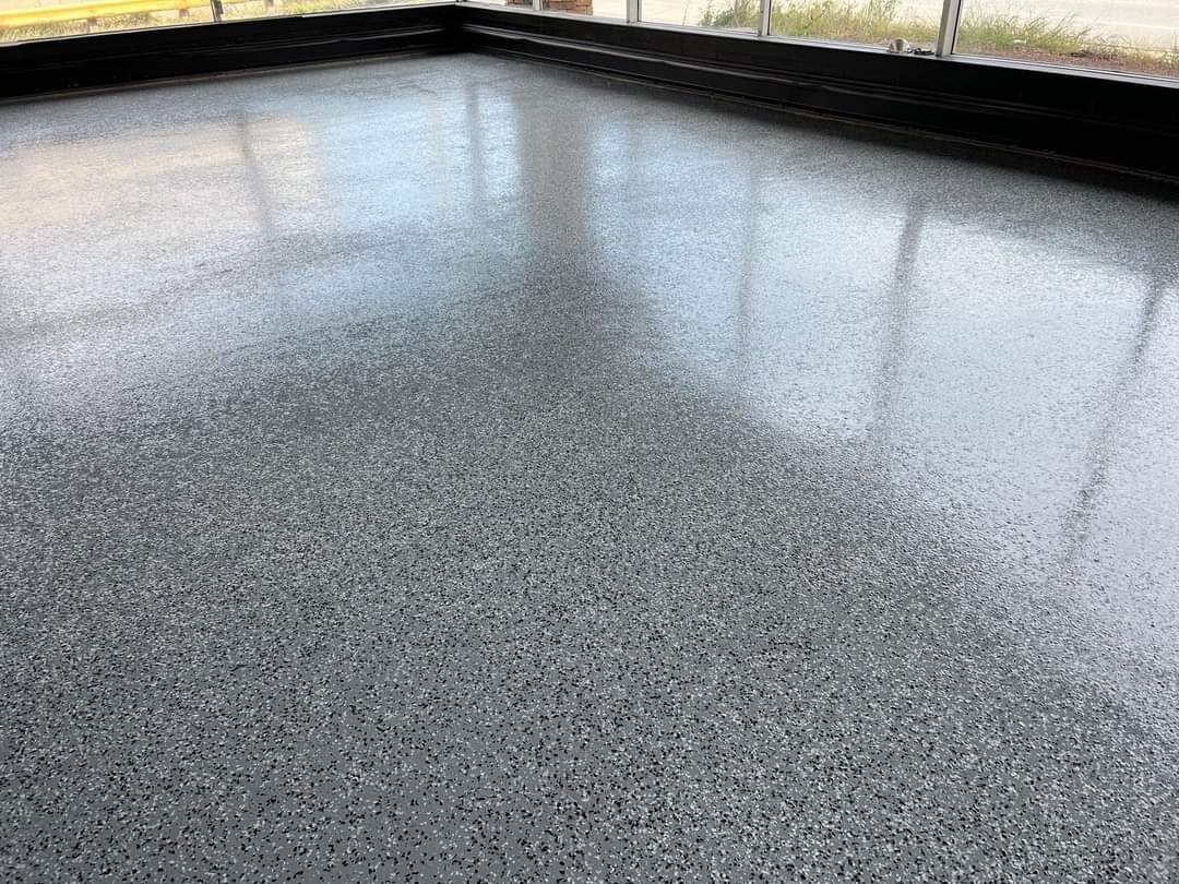 Flake epoxy floor beside large windows