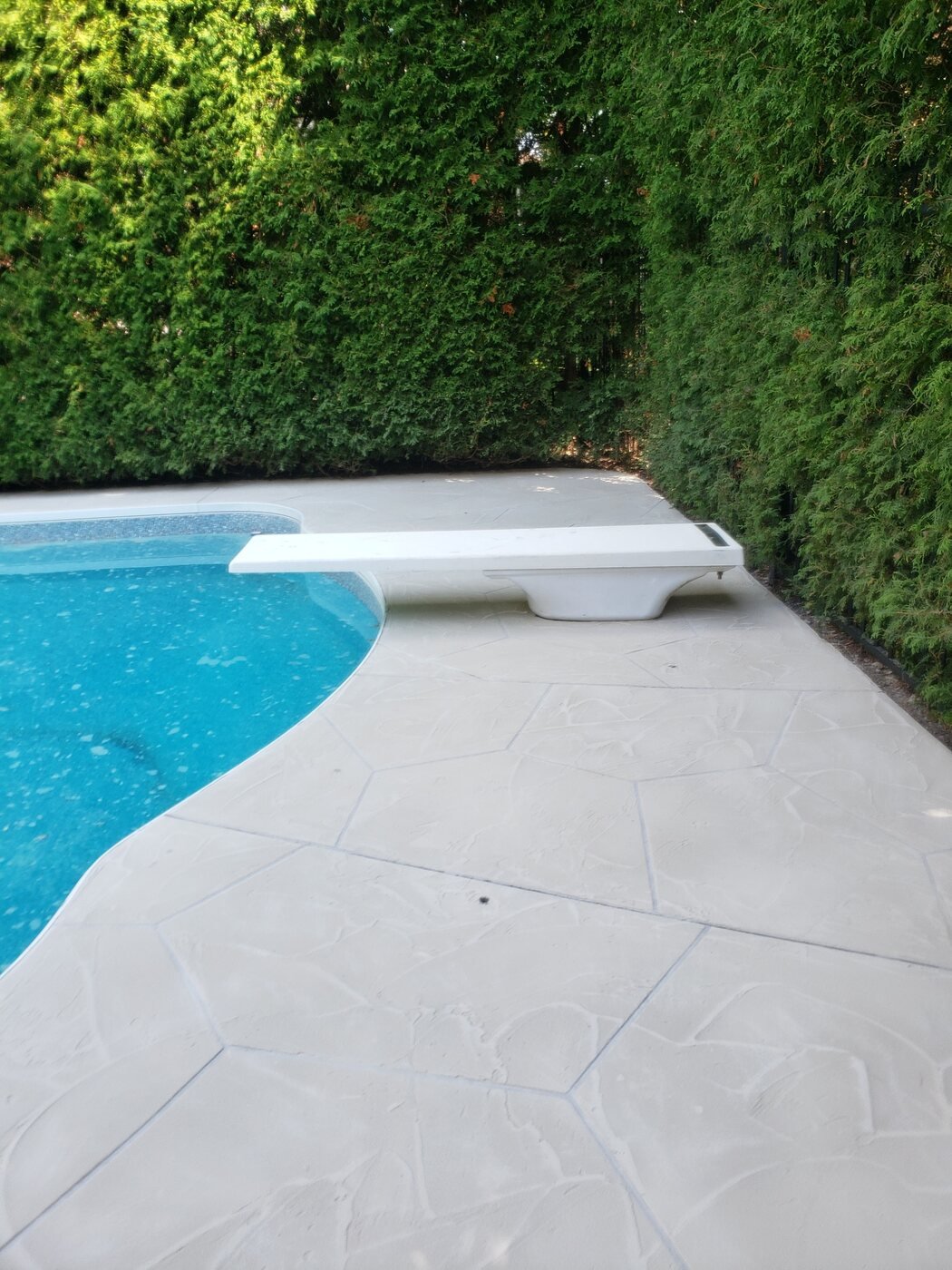 Decorative concrete overlay around a pool